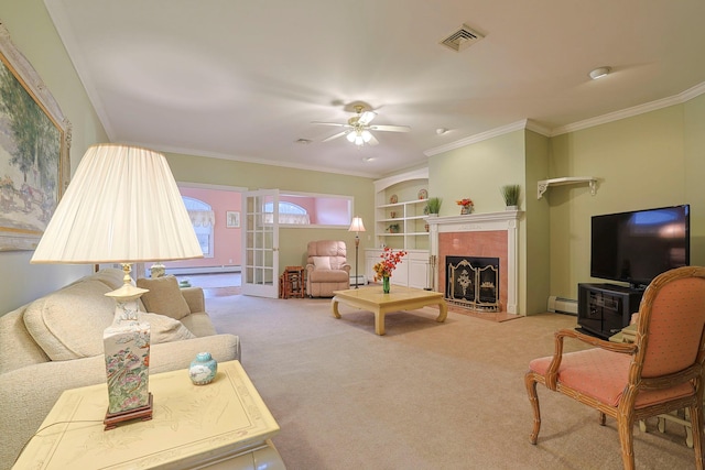 living room featuring built in shelves, ornamental molding, baseboard heating, and carpet floors