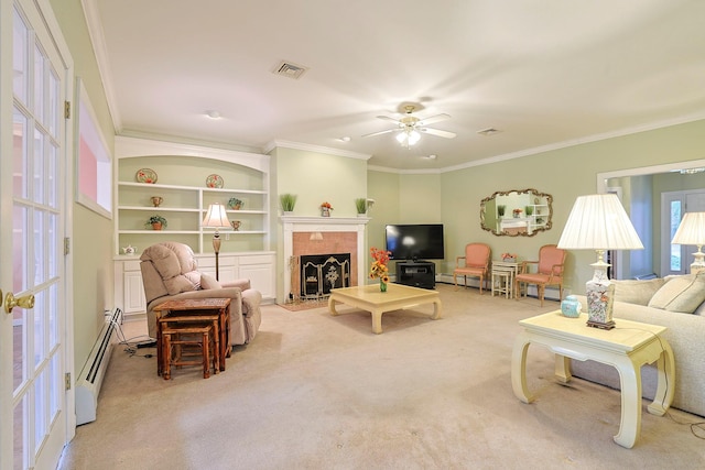 living room featuring light carpet, a tile fireplace, a baseboard heating unit, ceiling fan, and ornamental molding