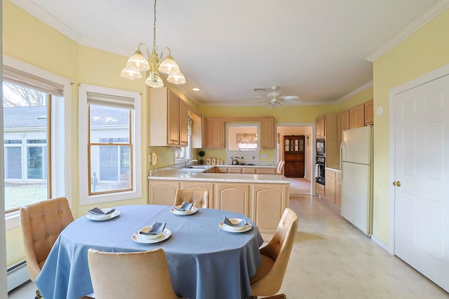 kitchen featuring oven, sink, decorative light fixtures, white fridge, and kitchen peninsula