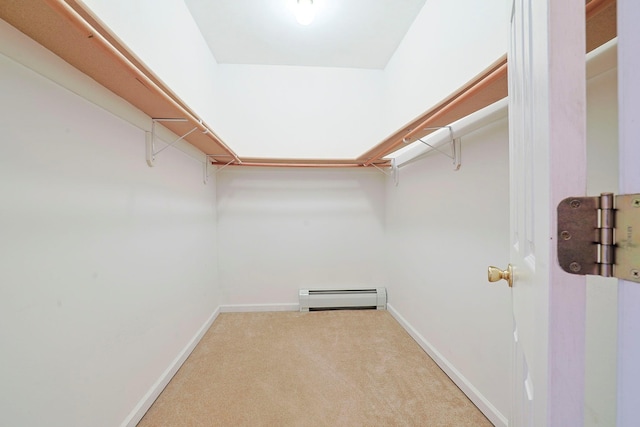 spacious closet featuring baseboard heating and carpet flooring