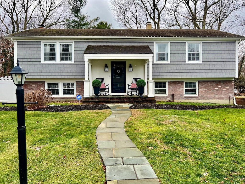 bi-level home with a front lawn