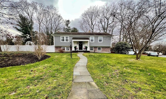 raised ranch featuring a front yard