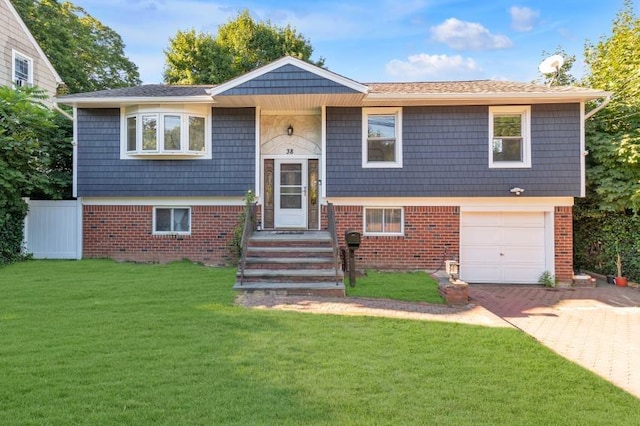 raised ranch with a garage and a front yard