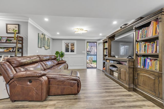 living room with crown molding and light hardwood / wood-style flooring