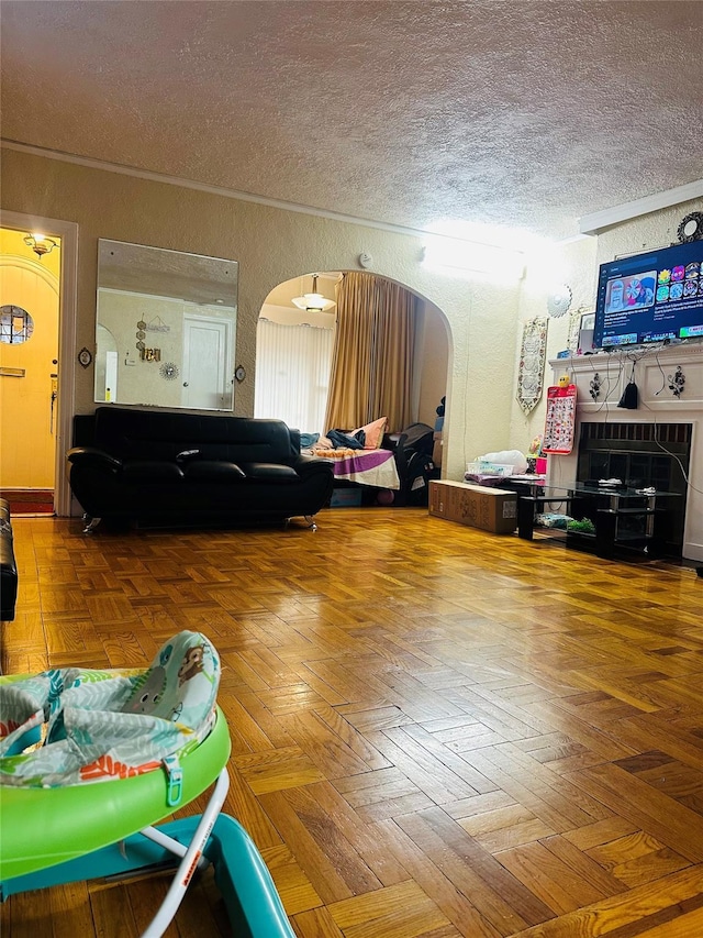 living room featuring parquet flooring and a textured ceiling