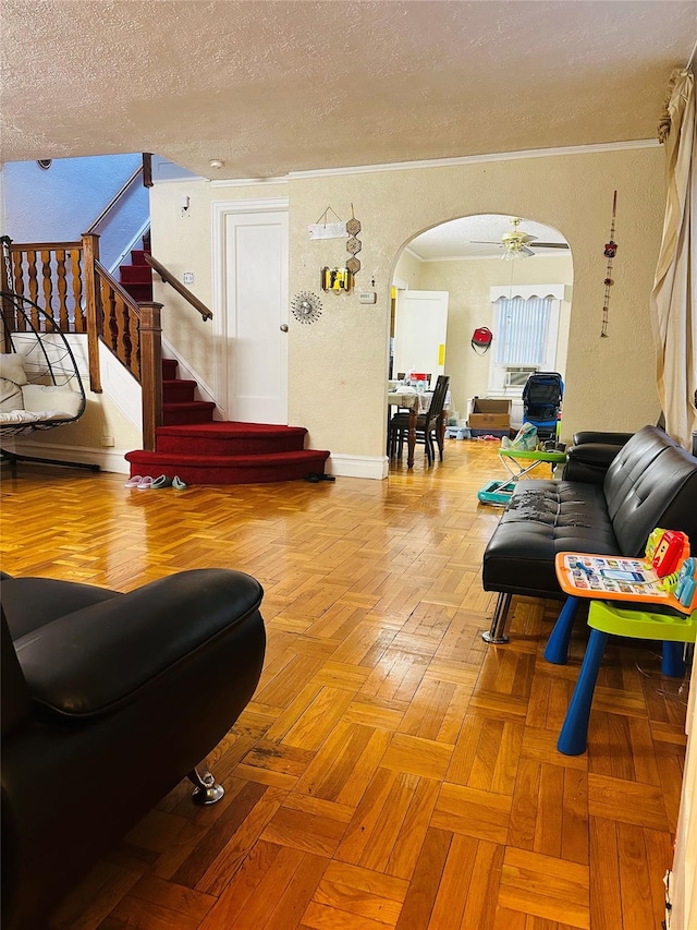 living room featuring a textured ceiling, light parquet floors, and ceiling fan