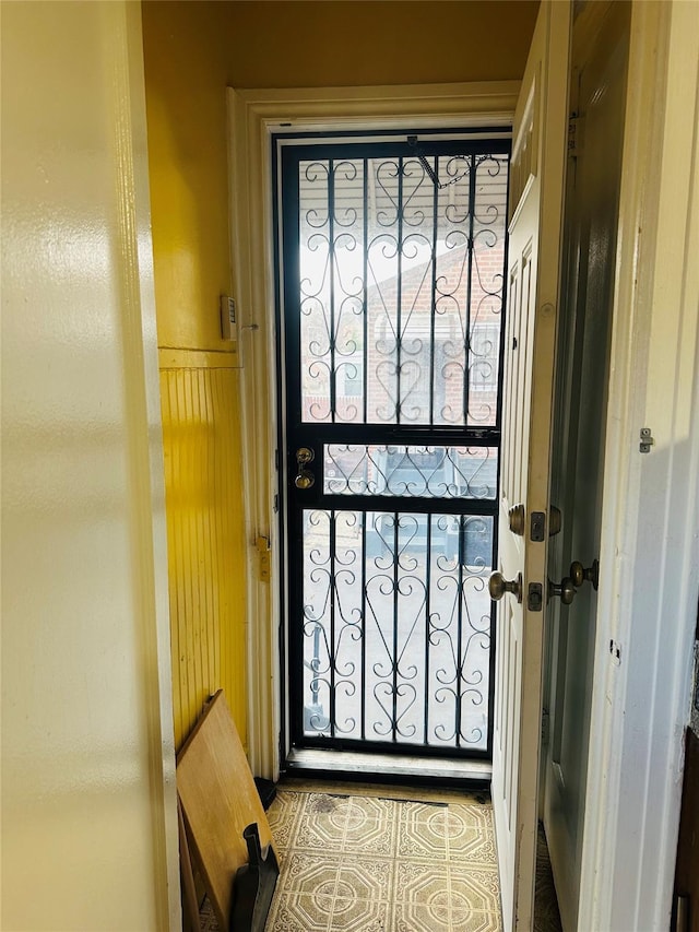 doorway to outside with tile patterned flooring