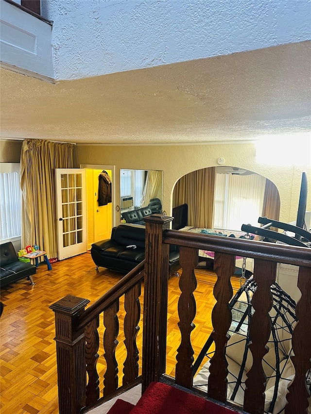 interior space with parquet floors and a textured ceiling