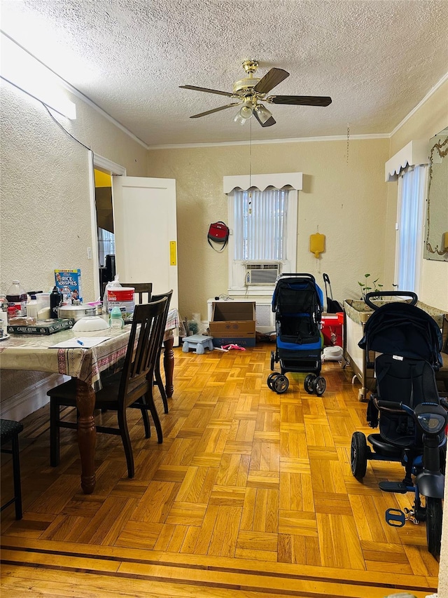 dining space with radiator, crown molding, ceiling fan, a textured ceiling, and light parquet flooring