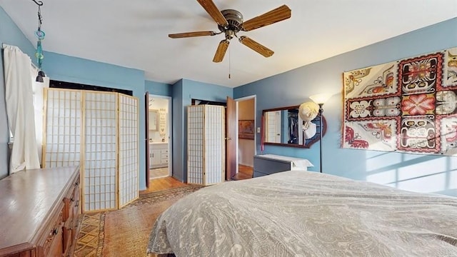 bedroom featuring ensuite bathroom, ceiling fan, and light hardwood / wood-style flooring