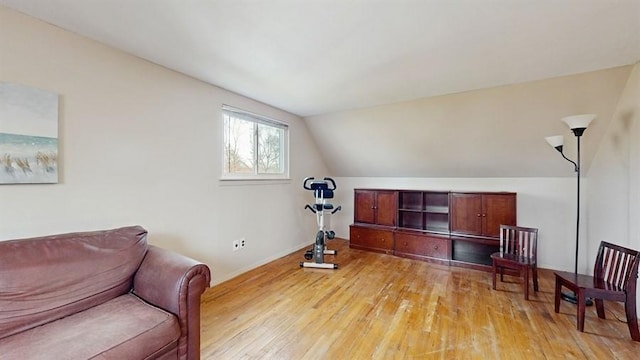 living area featuring lofted ceiling and light wood-type flooring