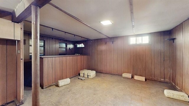 basement with wood walls and indoor bar