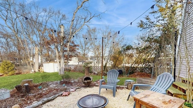 view of patio with a fire pit and a storage shed