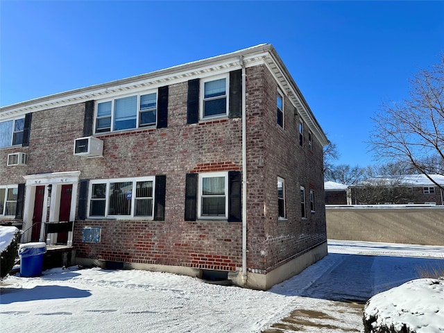 view of front of property with a wall mounted AC