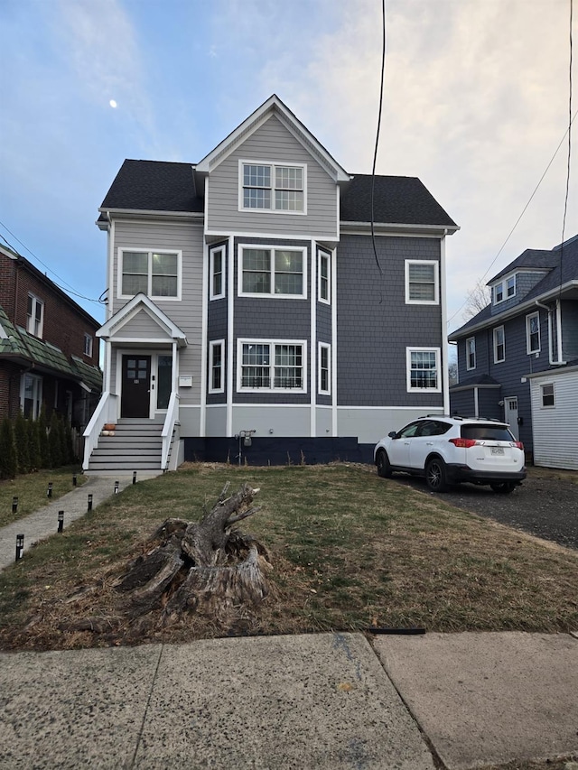 front facade with a front yard