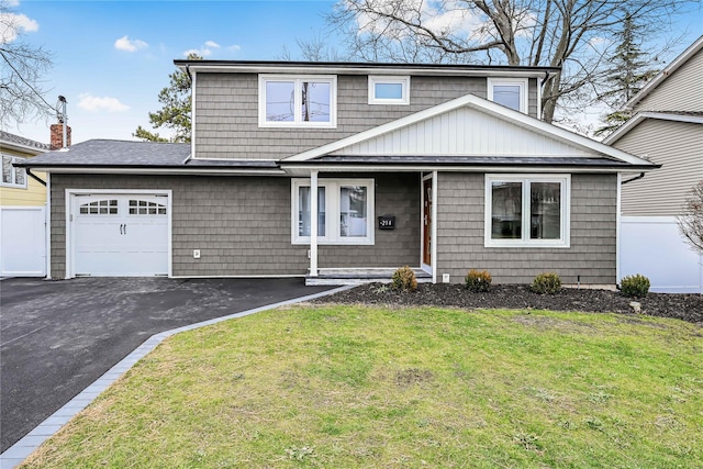 view of front of house featuring a garage and a front lawn