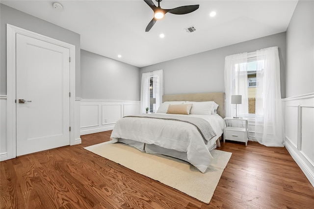 bedroom featuring multiple windows, ceiling fan, and wood-type flooring