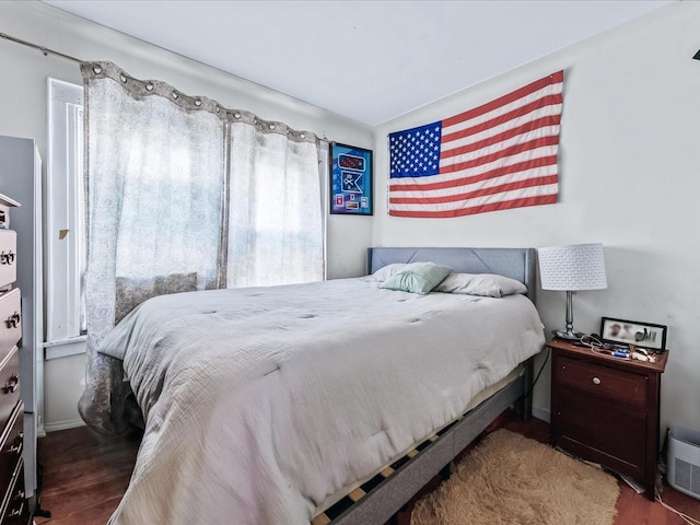 bedroom with dark wood-type flooring