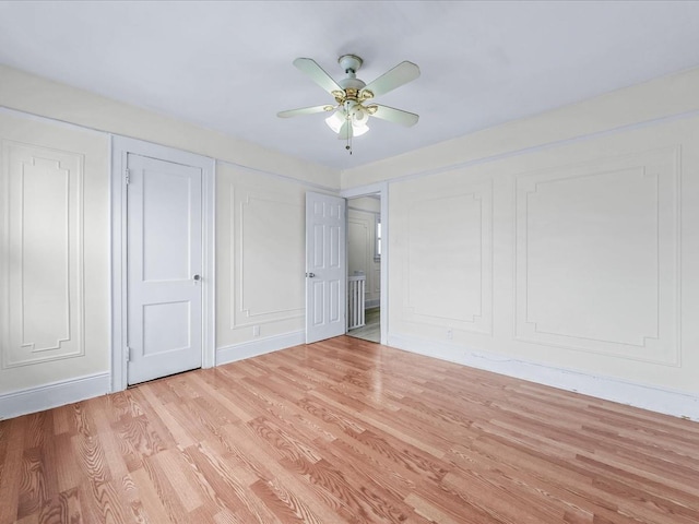 unfurnished bedroom with ceiling fan and light hardwood / wood-style floors