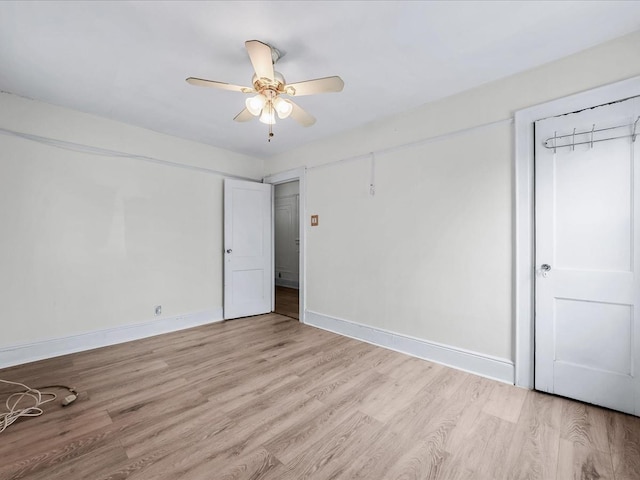 unfurnished bedroom with ceiling fan and light wood-type flooring