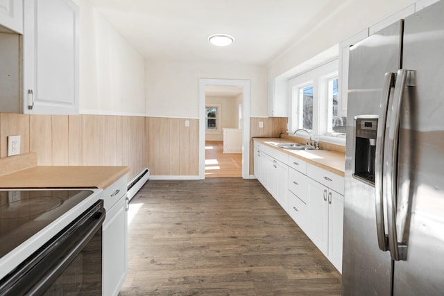 kitchen featuring stainless steel refrigerator with ice dispenser, sink, baseboard heating, dark hardwood / wood-style floors, and white cabinets