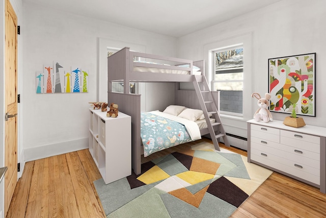 bedroom featuring a baseboard radiator and light wood-type flooring