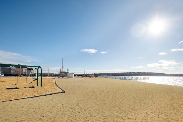 view of property's community featuring a water view and a playground