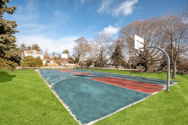 view of sport court featuring a yard