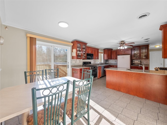 11 Balanchine Ct, Airmont, NY 10952 - kitchen with stainless steel appliances, a ceiling fan, decorative backsplash, light countertops, and glass insert cabinets