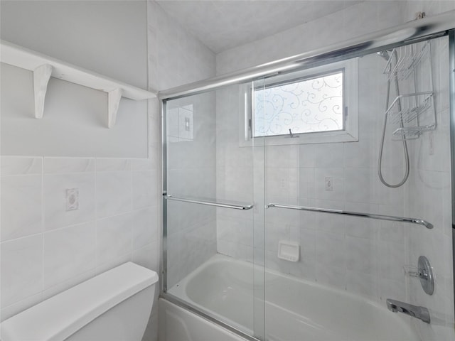 11 Balanchine Ct, Airmont, NY 10952 - bathroom featuring toilet, enclosed tub / shower combo, and tile walls