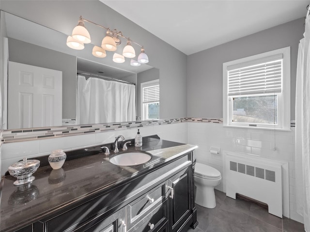 11 Balanchine Ct, Airmont, NY 10952 - bathroom with radiator, vanity, toilet, tile walls, and tile patterned floors