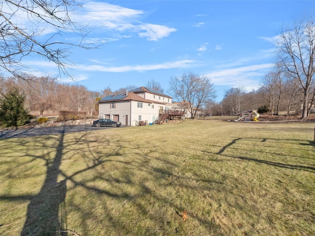 11 Balanchine Ct, Airmont, NY 10952 - view of green lawn featuring stairway, a playground, and a deck