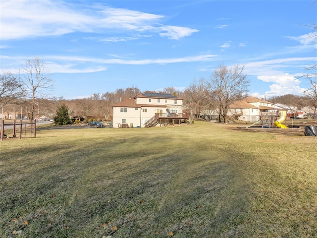 11 Balanchine Ct, Airmont, NY 10952 - view of green lawn featuring stairway, a playground, and a wooden deck