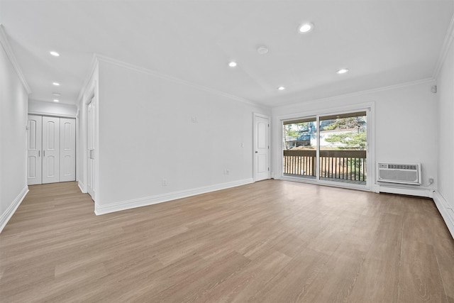 unfurnished living room featuring light wood-type flooring, a wall mounted AC, and crown molding