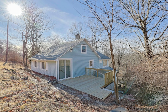 rear view of house featuring a wooden deck