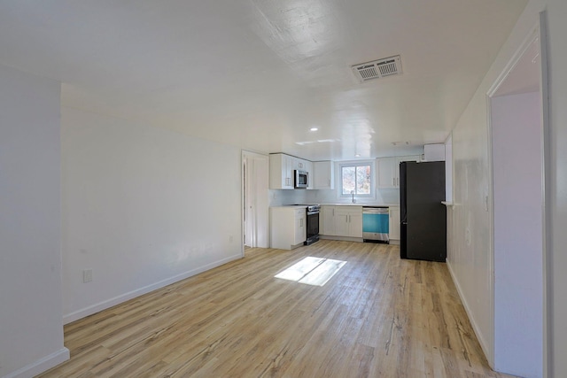 kitchen featuring light hardwood / wood-style flooring, white cabinets, stainless steel appliances, and sink