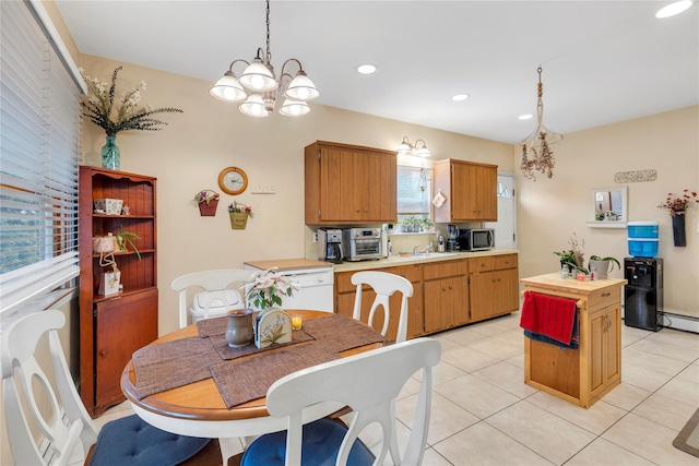 tiled dining room featuring sink, a baseboard radiator, and an inviting chandelier