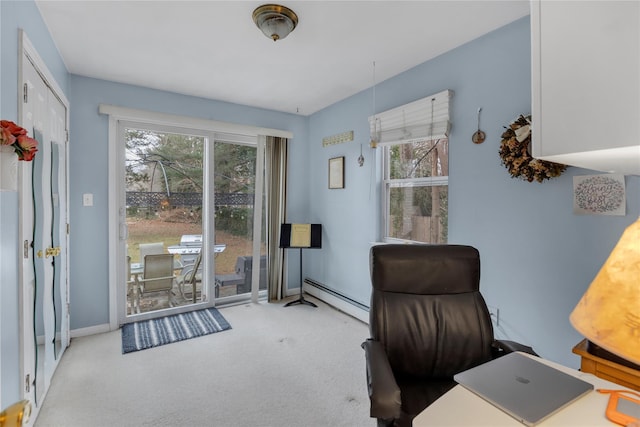 carpeted office with a baseboard heating unit