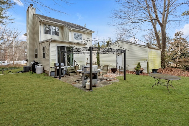 rear view of house featuring central air condition unit, a gazebo, and a lawn