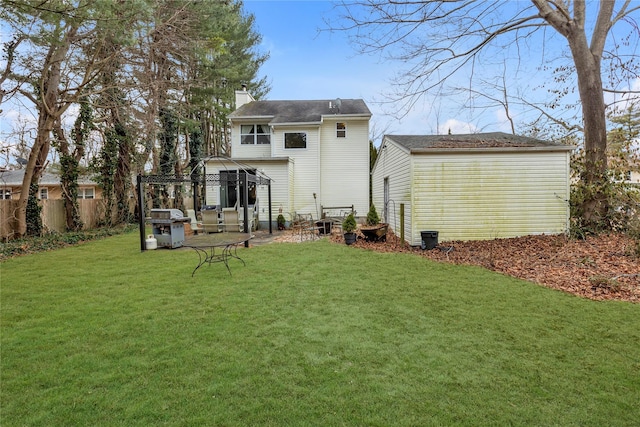 rear view of house with a gazebo and a yard