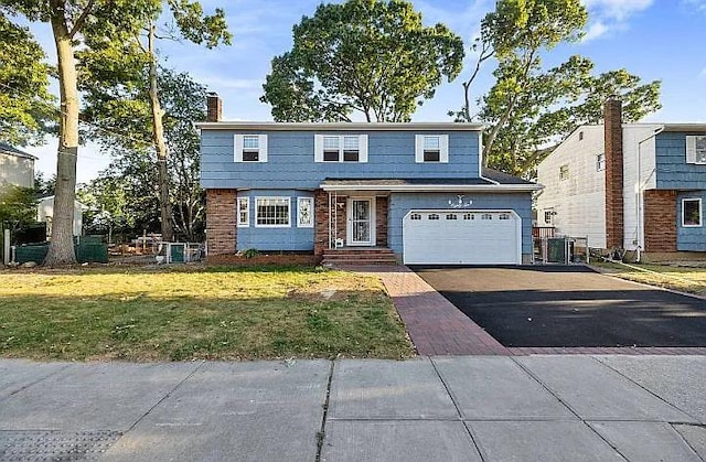 view of front property featuring a garage and a front lawn