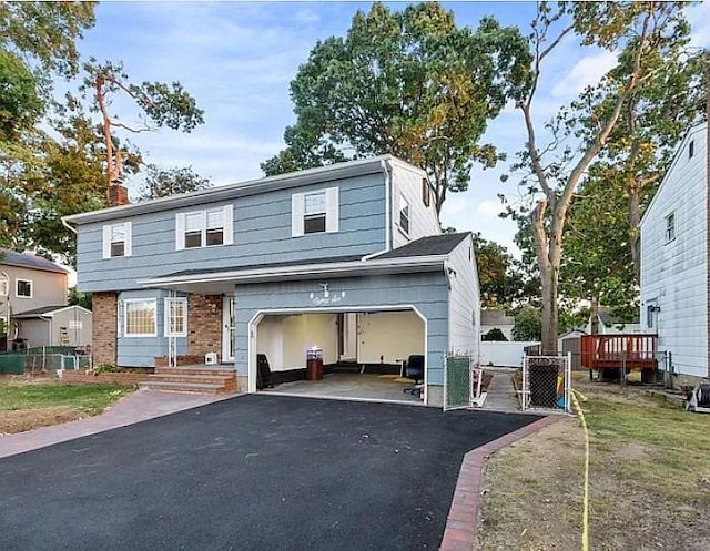 view of front of property with a garage and a front lawn