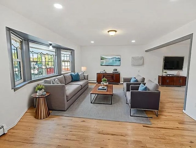 living room featuring baseboard heating and light wood-type flooring