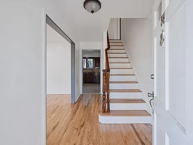 staircase with wood-type flooring