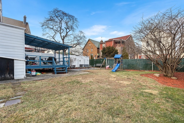 view of yard with a deck and a playground