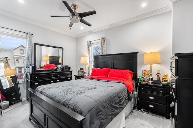 bedroom featuring ceiling fan, light colored carpet, and ornamental molding