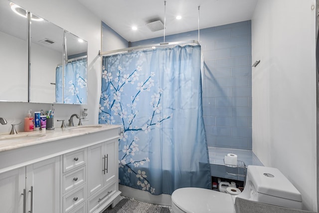 full bathroom with shower / bath combo with shower curtain, toilet, and vanity