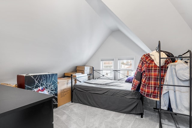 bedroom with light carpet and vaulted ceiling