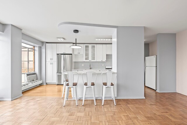 2727 Palisade Ave Unit 16Ab, Bronx, NY 10463 - kitchen featuring stainless steel refrigerator, freestanding refrigerator, light countertops, glass insert cabinets, and decorative backsplash
