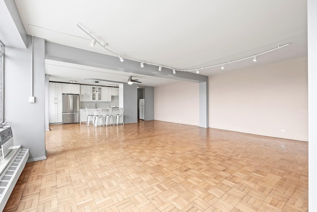 2727 Palisade Ave Unit 16Ab, Bronx, NY 10463 - unfurnished living room featuring track lighting, ceiling fan, and baseboards
